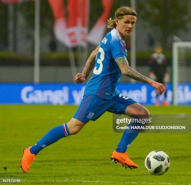 Iceland's defender Ari Skulason runs with the ball during the international friendly football match Iceland v Norway in Reykjavik, Iceland on June 2,...