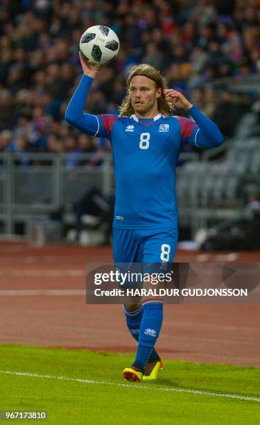 Iceland's midfielder Birkir Bjarnason throws in the ball during the international friendly football match Iceland v Norway in Reykjavik, Iceland on...