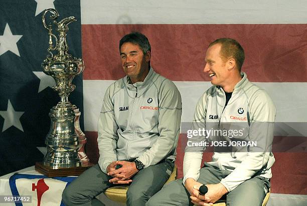 New Zealand's Oracle CEO Russell Coutts and Australian skipper and helmsman James Spithill share a smile during a press conference in Valencia on...