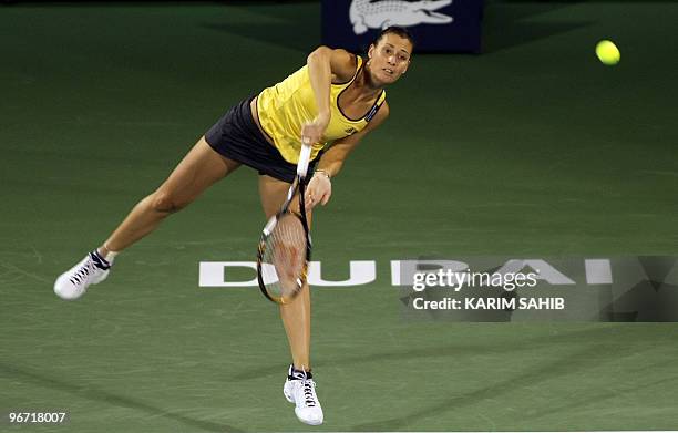 Flavia Pennetta of Italy serves during her first round match against Melinda Czink of Hungary during day two of the WTA Dubai Tennis Championships on...