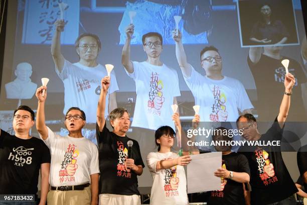 Pro-democracy protestors hold candles on a stage during a vigil in Hong Kong on June 4 to mark the 29th anniversary of the 1989 Tiananmen crackdown...