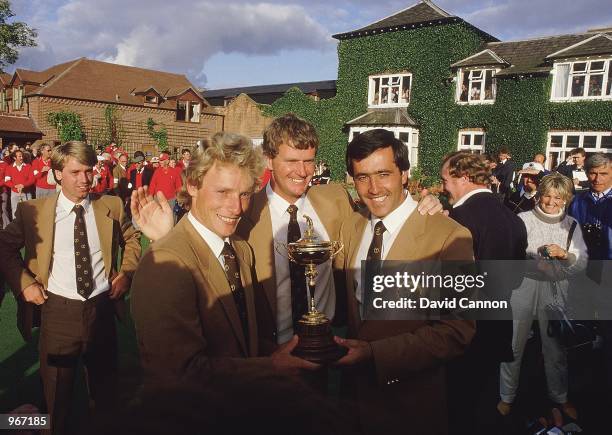 Bernhard Langer, Sandy Lyle and Seve Ballesteros of the European team with the trophy after victory over the USA in the Ryder Cup at the Belfry in...