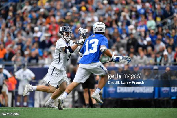 Sean Cerrone of Duke University defends Lucas Cotler of Yale University during the Division I Men's Lacrosse Championship Semifinals held at Gillette...