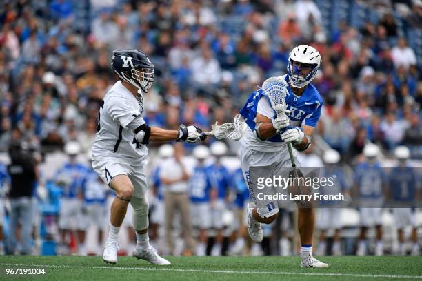 Jason Alessi of Yale University defends against Brad Smith of Duke University during the Division I Men's Lacrosse Championship Semifinals held at...