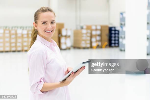 attractive manager of new warehouse - yoh4nn stock pictures, royalty-free photos & images