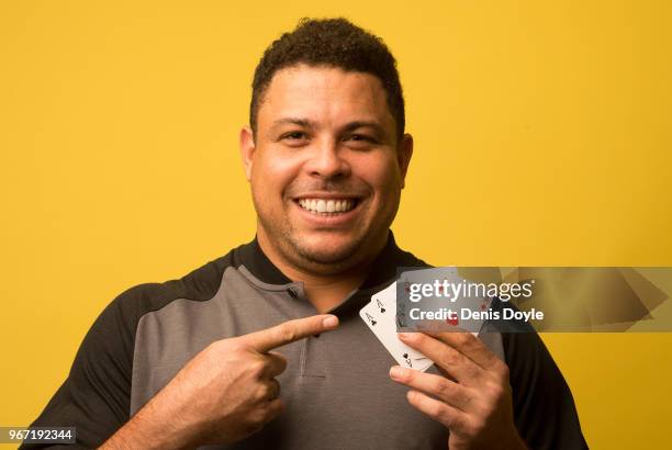 Ronaldo Nazario, winner with Brazil of the FIFA 2002 World Cup final against Germany holds four aces during a photo shoot on March 12, 2018 in...