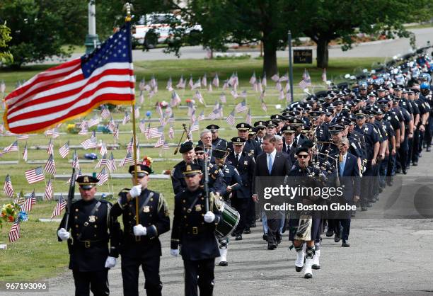 Massachusetts Governor Charlie Baker and Boston Mayor Martin J. Walsh march in the procession during the Boston Police Department's annual Mass and...