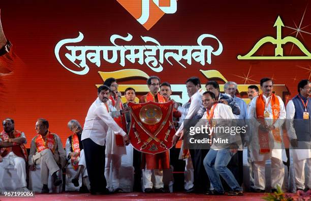 Shiv Sena President Uddhav Thackeray with son Aditya Thackeray during event commemorating 50th anniversary of Shiv Sena on June 19, 2016 in Mumbai,...