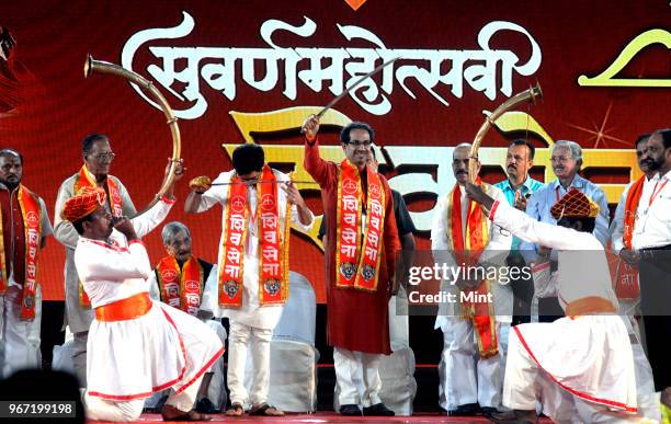 Shiv Sena President Uddhav Thackeray with son Aditya Thackeray during event commemorating 50th anniversary of Shiv Sena on June 19, 2016 in Mumbai,...