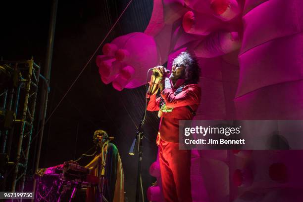 Guitarist Steven Drozd and singer and guitarist Wayne Coyne of The Flaming Lips perform live on stage in front of a giant pink inflatable robot...