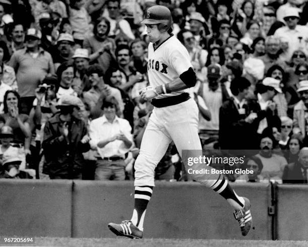 Boston Red Sox player Carlton Fisk runs home after hitting a home run during a game at Fenway Park in Boston on Aug. 12, 1978.