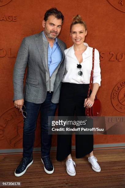 Actors Clovis Cornillac and his wife Lilou Fogli attend the 2018 French Open - Day Nine at Roland Garros on June 4, 2018 in Paris, France.
