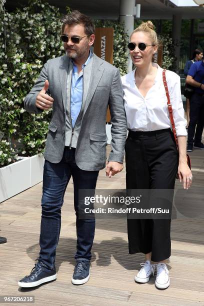 Actors Clovis Cornillac and his wife Lilou Fogli attend the 2018 French Open - Day Nine at Roland Garros on June 4, 2018 in Paris, France.