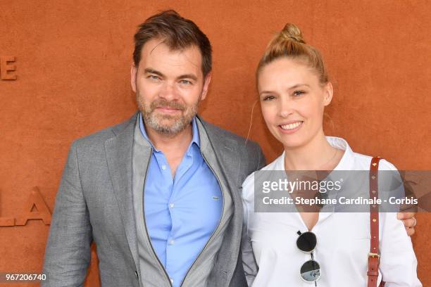 Actors Clovis Cornillac and Lilou Fogli attend the 2018 French Open - Day Nine at Roland Garros on June 4, 2018 in Paris, France.