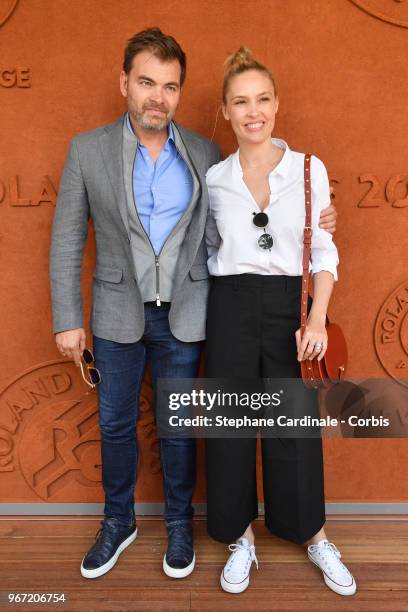 Actors Clovis Cornillac and Lilou Fogli attend the 2018 French Open - Day Nine at Roland Garros on June 4, 2018 in Paris, France.