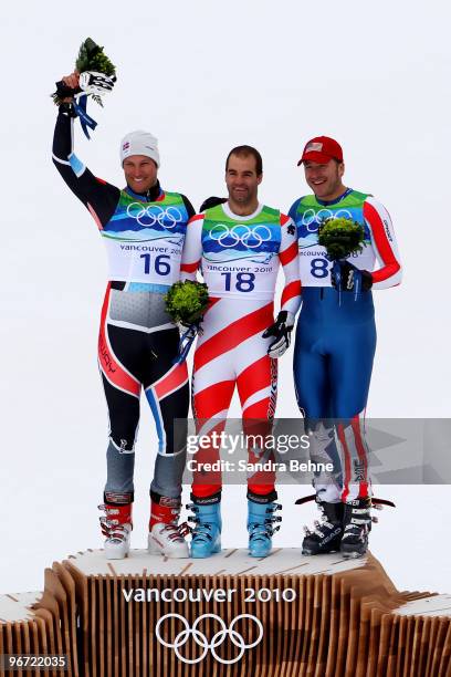 Aksel Lund Svindal of Norway, Didier Defago of Switzerland and Bode Miller of the United States celebrate after the Alpine skiing Men's Downhill at...