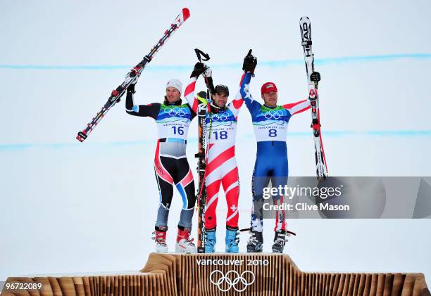 Aksel Lund Svindal of Norway, Didier Defago of Switzerland and Bode Miller of the United States celebrate after the Alpine skiing Men's Downhill at...