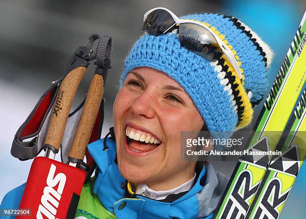 Charlotte Kalla of Sweden smiles after winning the gold during the flower ceremony for the women's cross-country skiing 10 km final on day 4 of the...