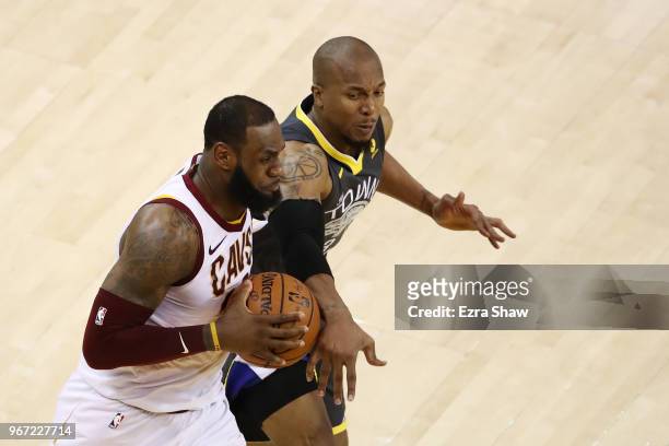 LeBron James of the Cleveland Cavaliers drives against David West of the Golden State Warriors in Game 2 of the 2018 NBA Finals at ORACLE Arena on...