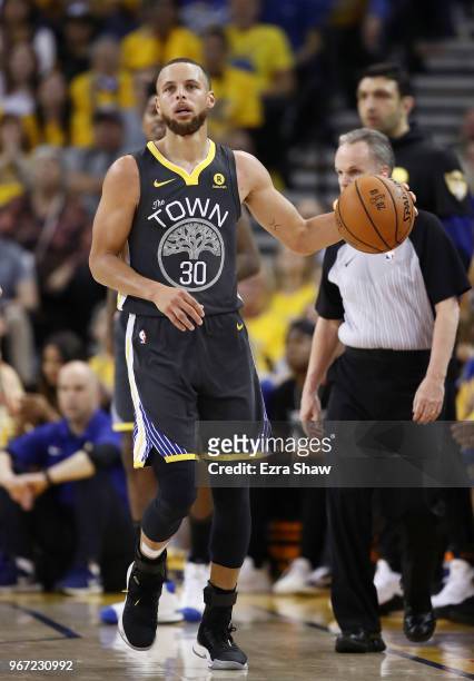 Stephen Curry of the Golden State Warriors controls the ball against the Cleveland Cavaliers in Game 2 of the 2018 NBA Finals at ORACLE Arena on June...