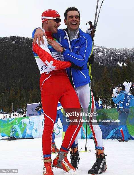 Dario Cologna of Switzerland and Pietro Piller Cottrer of Italy celebrate preliminary gold and silver respectively in the men's cross-country skiing...