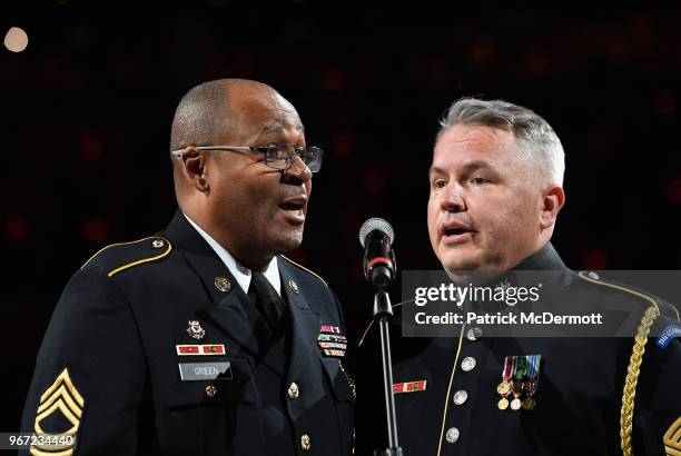 Army Master Sgt. Caleb Green and Master Sgt. Bob McDonald sing the national anthem before Game Three of the 2018 NHL Stanley Cup Final between the...