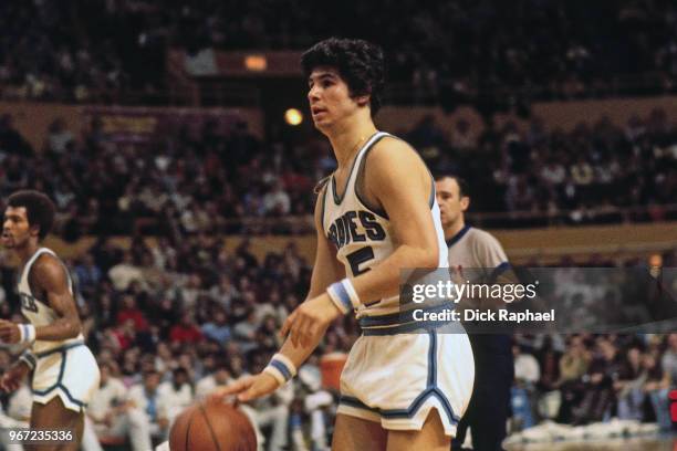 Ernie DiGregorio of the Buffalo Braves handles the ball against the Boston Celtics during the game circa 1974 at the Buffalo Memorial Auditorium in...