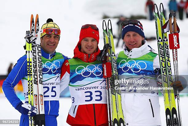 Pietro Piller Cottrer of Italy celebrates winning silver, Dario Cologna of Switzerland gold and Lukas Bauer of Czech Republic bronze during the...