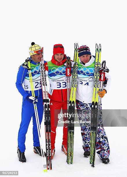 Pietro Piller Cottrer of Italy celebrates winning silver, Dario Cologna of Switzerland gold and Lukas Bauer of Czech Republic bronze during the...