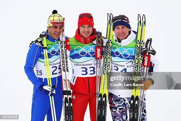 Pietro Piller Cottrer of Italy celebrates winning silver, Dario Cologna of Switzerland gold and Lukas Bauer of Czech Republic bronze during the...