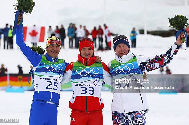 Pietro Piller Cottrer of Italy celebrates winning silver, Dario Cologna of Switzerland gold and Lukas Bauer of Czech Republic bronze during the...