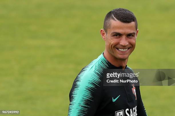 Portugal's forward Cristiano Ronaldo smiles during a training session at Cidade do Futebol training camp in Oeiras, outskirts of Lisbon, on June 4...