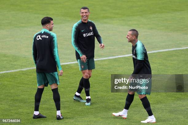 Portugal's forward Cristiano Ronaldo laughs with Portugal's forward Ricardo Quaresma and Portugal's defender Pepe during a training session at Cidade...