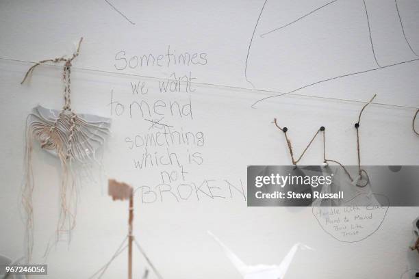 Line and Mend Pieces create a web on string on the walls and about four feet off the ground. The lines are the string that hangs with pieces of cups...