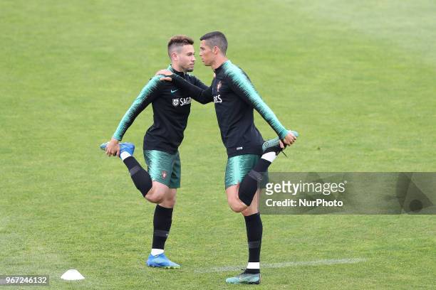 Portugal's forward Cristiano Ronaldo warms up with Portugal's defender Raphael Guerreiro during a training session at Cidade do Futebol training camp...