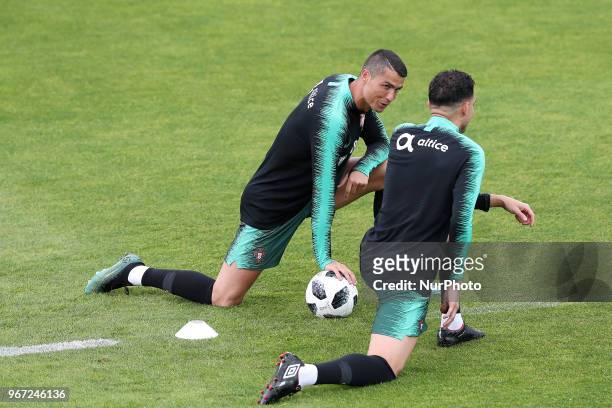 Portugal's forward Cristiano Ronaldo chats with Portugal's defender Pepe during a training session at Cidade do Futebol training camp in Oeiras,...