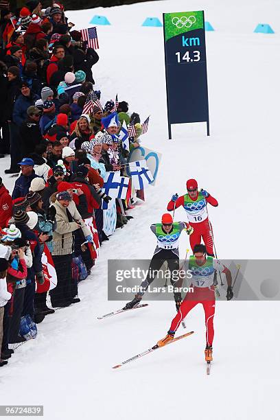 Curdin Perl of Switzerland leads Tobias Angerer of Germany and Martin Johnsrud Sundby of Norway during the Cross-Country Skiing Men's 15 km Free on...