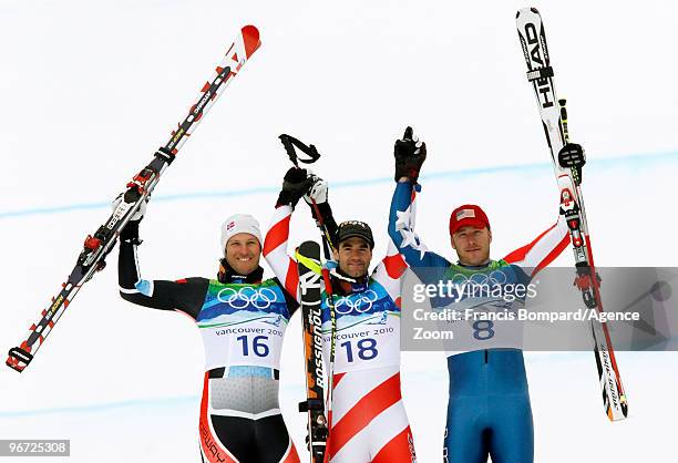 Aksel Lund Svindal of Norway, Didier Defago of Switzerland and Bode Miller of the United States celebrate after the Alpine skiing Men's Downhill at...