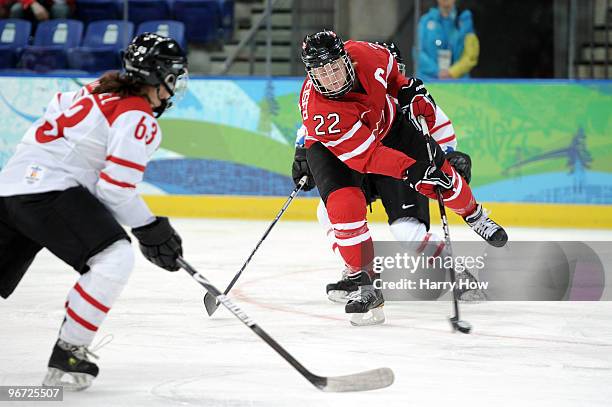 Hayley Wickenheiser of Canada skates with the puck during the Women's preliminary ice hockey game between Switzerland and Canada on day 4 of the...