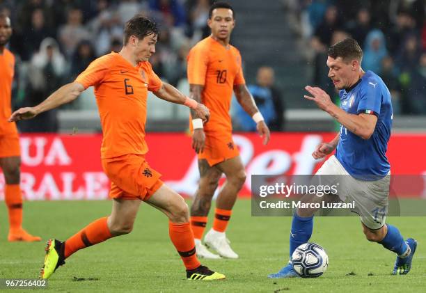 Andrea Belotti of Italy competes for the ball with Marten De Roon of Netherlands during the International Friendly match between Italy and...