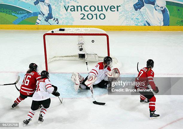 Meghan Agosta of Canada scores past goalkeeper Florence Schelling of Switzerland during the Women's preliminary game between Switzerland and Canada...