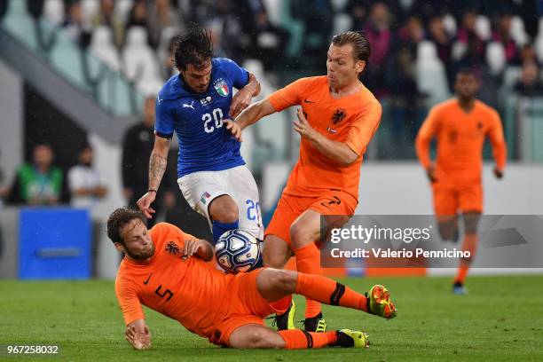 Simone Verdi of Italy competes for the ball with Daley Blind and Hans Hateboer of Netherlands during the International Friendly match between Italy...