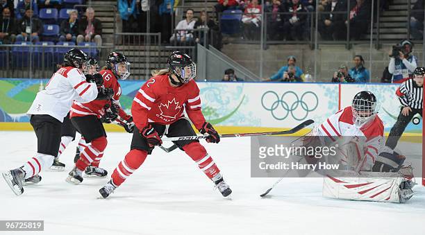 Meghan Agosta of Canada scores past goalkeeper Florence Schelling of Switzerland during the Women's preliminary game between Switzerland and Canada...