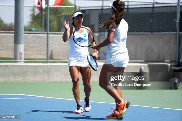 Ines Nicault of the University of West Florida high fives her teammate Lais Bicca as they take on Barry University during the Division II Women's...