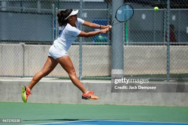 Lais Bicca of the University of West Florida returns a ball against Barry University during the Division II Women's Tennis Championship held at the...