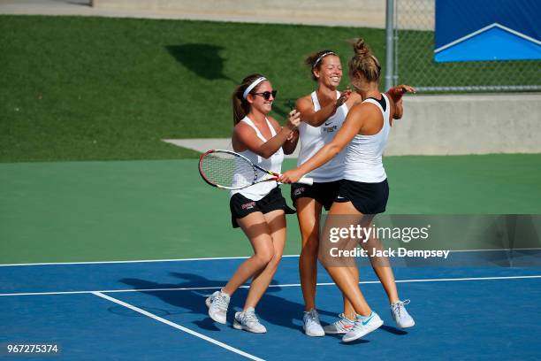 Sonja Larsen of Barry University celebrates with teammates after winning her match against the University of West Florida during the Division II...