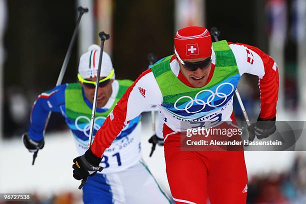 Dario Cologna of Switzerland crosses the line to take eventual gold during the Cross-Country Skiing Men's 15 km Free on day 4 of the 2010 Winter...