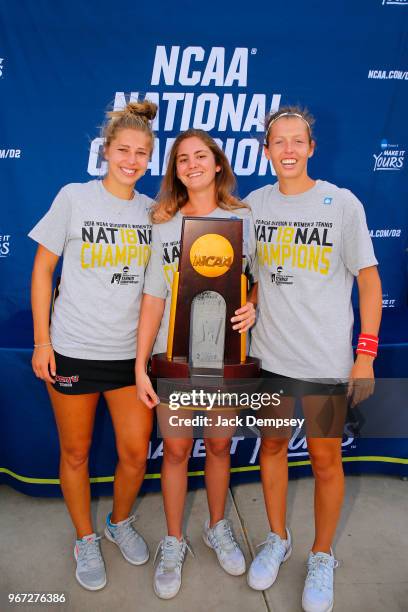 Sonja Larsen, Mara Cerrini, and Judith Bohnenkamp of Barry University celebrate with the trophy during the Division II Women's Tennis Championship...