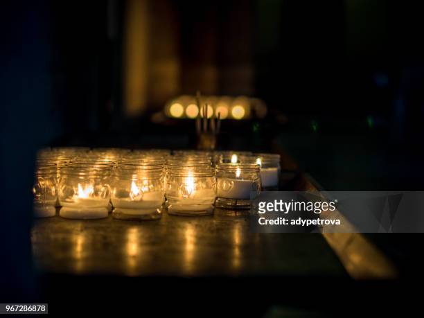 tea light candles in a church, basilica of sant'ambrogio, milan, lombardy, italy - church of santambrogio stock pictures, royalty-free photos & images