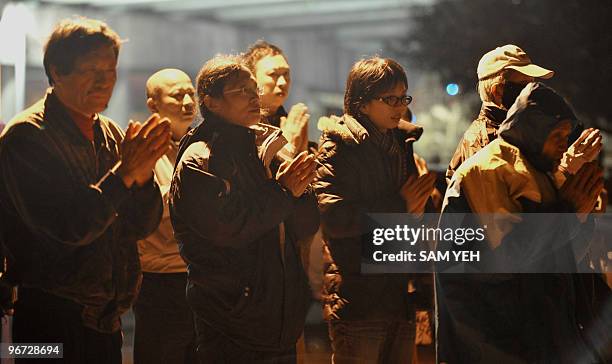 "Taiwan-conservation-animal-religion", FEATURE by Amber Wang Taiwanese Buddhists recite prayers after a "mercy release" ceremony in Taipei on January...